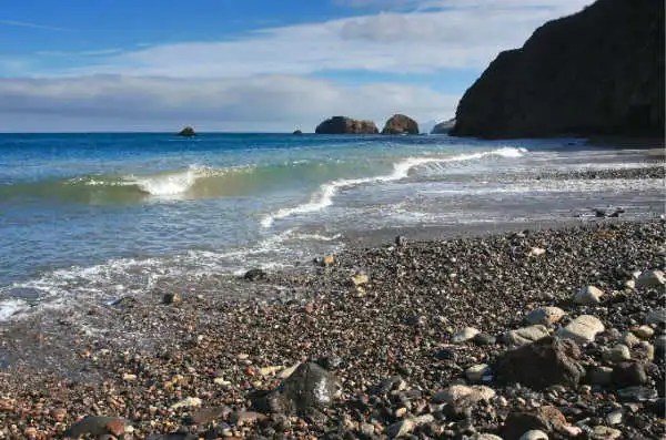 a group of people on a rocky beach