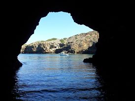 a cave next to a body of water